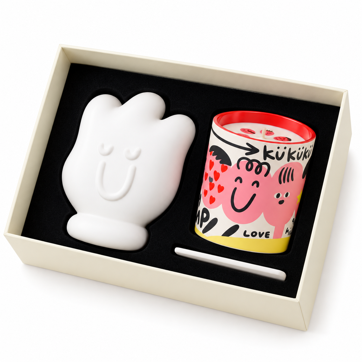 Confezione regalo Mood aperta con candela profumata da 200 g decorata con illustrazioni rosa e supporto bianco a forma di mano.