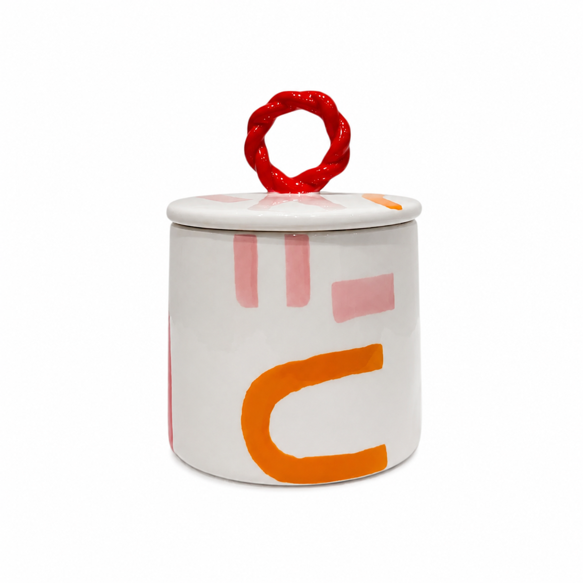 Barattolo Mónica e Verónica di Qué Rico in ceramica bianca con pennellate rosa e arancioni, coperchio bianco e pomello rosso intrecciato, su fondo bianco.
