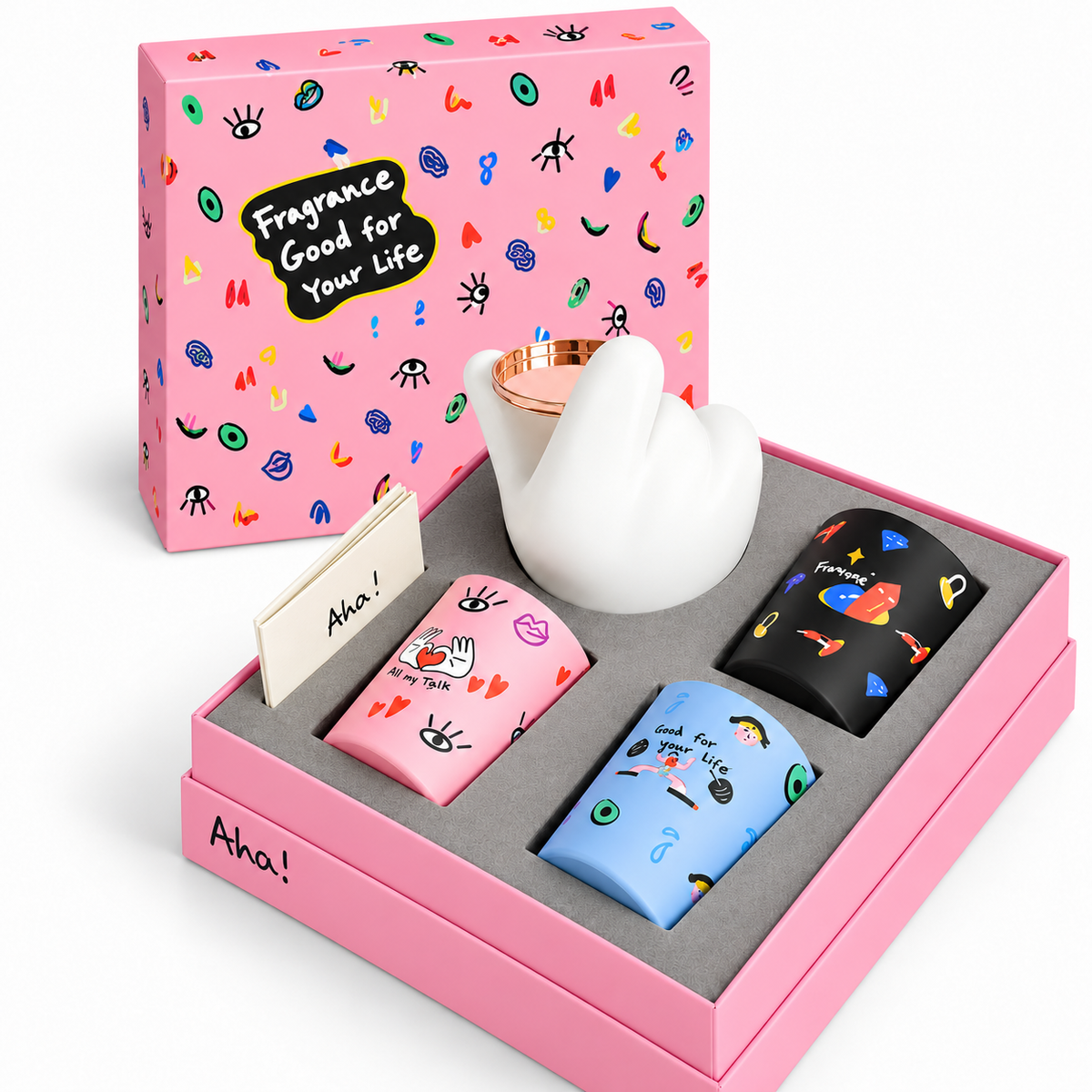 Gift Box Aha! Collection 02 con tre candele profumate, mano decorativa bianca e confezione regalo illustrata
