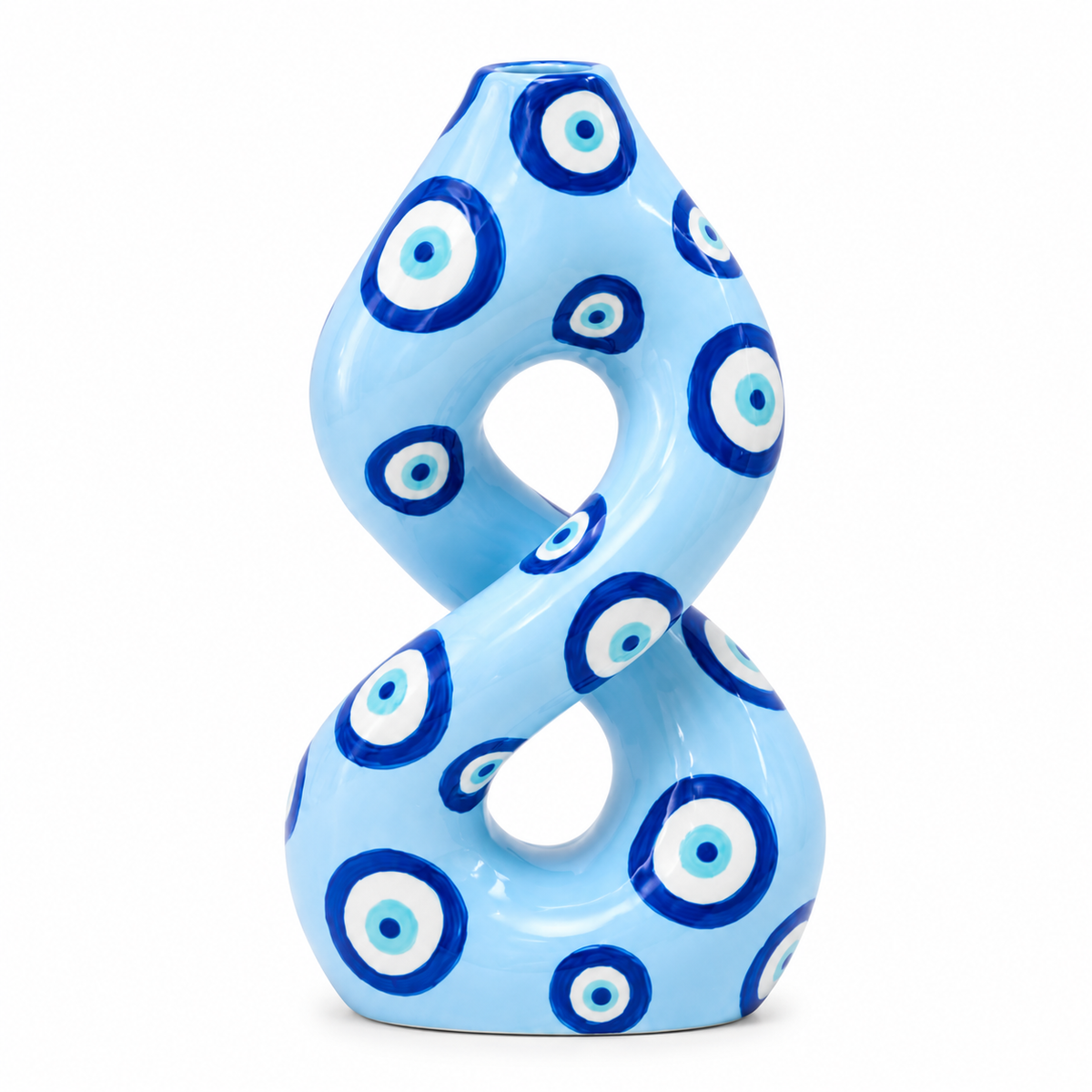 Vaso Patricia Qué Rico in ceramica azzurra con motivi circolari blu e bianchi, forma scultorea a otto, su fondo bianco.